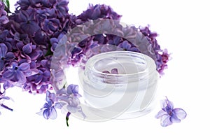 cosmetic cream in white tubes with sprigs of lilac flowers. Spa treatments for home care. Home