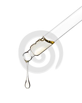 Cosmetic dropper with yellow oil. Glass dropper isolated on a white background. Path saved