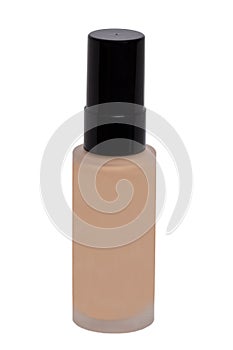 Cosmetic foundation isolated. Close-up of an closed glass bottle with liquid skin foundation isolated on a white background.