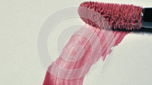 Cosmetic liquid lip gloss, lipstick smudge, smear, stroke. Brush, applicator lip gloss make up smears isolated on a