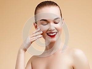 Cosmetic and Makeup. Beauty Fashion Model Woman face. Portrait with perfect skin. Red Lips and Nails