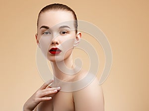 Cosmetic and Makeup. Beauty Fashion Model Woman face. Portrait with perfect skin. Red Lips and Nails