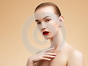 Cosmetic and Makeup. Beauty Fashion Model Woman face. Portrait with perfect skin. Red Lips and Nails