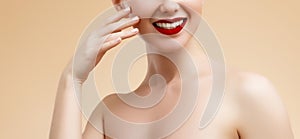 Cosmetic and Makeup. Beauty Fashion Model Woman face. Portrait with perfect skin. Red Lips and Nails