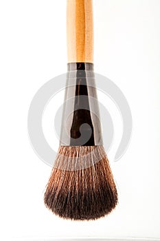 Cosmetic makeup brush on white blackground close up