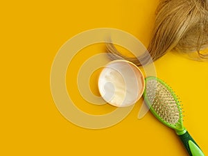 cosmetic mask for hair, comb on a colored background