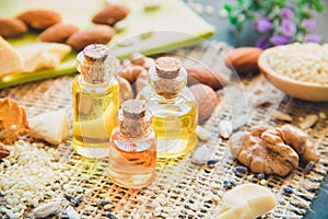 Cosmetic and medical oil of walnuts, almonds, cocoa butter close-up photo