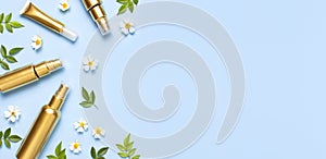 Cosmetic mock up gold bottles. Cosmetics, spring white flowers green leaves on blue background. Cosmetics springtime summer
