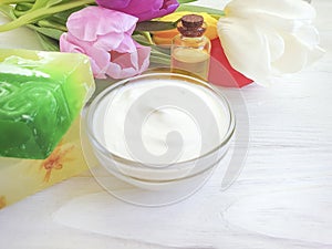 Cosmetic moisturizer beauty  cream product organic ointment soap beauty tulip flower on a white wooden background
