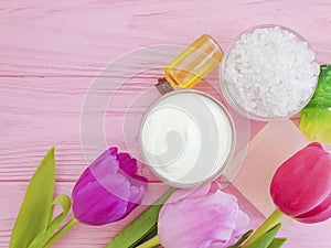 Cosmetic moisturizer beauty glass cream product organic ointment soap beauty tulip flower a pink wooden background