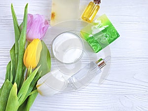 Cosmetic moisturizer cream product organic soap beauty tulip flower on a white wooden background