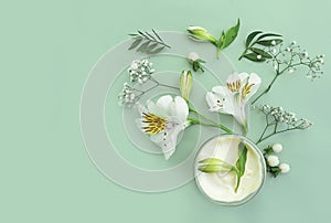 Cosmetic  natural cream,  wellness moisturizing fresh cleansing lifestyle floral design flower spring on a colored background