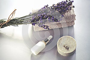 Cosmetic natural lavender soap bar and serum or essential oil. Aromatherapy, spa background