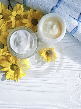 Cosmetic cream organic morning a jar yellow chrysanthemum flower white wooden, daisy, towel