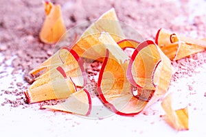 Cosmetic pencil shavings with powder on background
