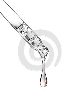 Cosmetic pipette with a drop close up on white background