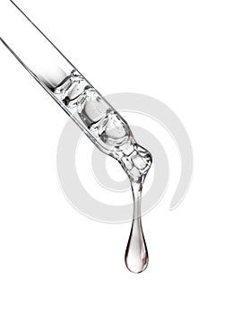 Cosmetic pipette with a drop close up on white background photo