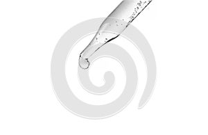 Cosmetic pipette with drops of cosmetic oil close-up on a white background. Liquid transparent gel, serum, emulsion