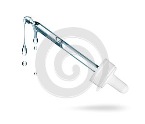 Cosmetic pipette with stretched drops close-up isolated on a white background