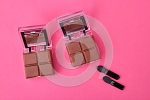 Cosmetic powder caces with chocolate.