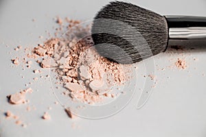 Cosmetic powder slide and black makeup brush