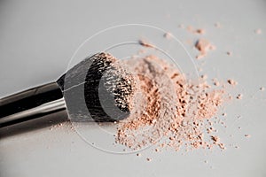 Cosmetic powder slide and black makeup brush