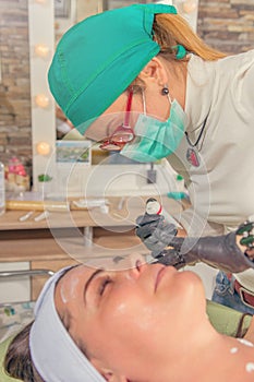 Cosmetic procedure at beauty salon. Beautician cosmetic treatment.