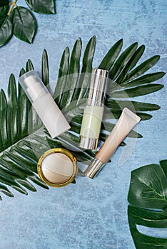Cosmetic product and tropical leaves on concert background