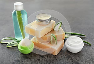 Cosmetic products with aloe on grey table