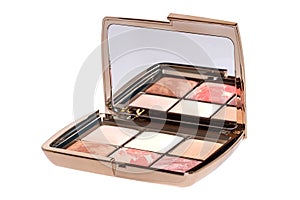 Cosmetic products isolated. Close-up of a elegant opened box with various cheek or face powder in it isolated on a white
