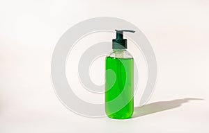 Cosmetic pump dispenser bottle filled with green liquid on white, aloe vera skincare product