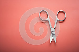 Cosmetic scissors on pink