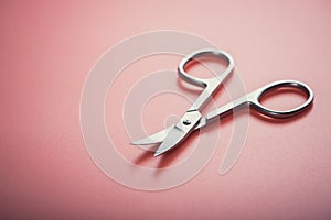 Cosmetic scissors on pink