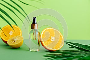 Cosmetic serum Vitamin C in glass bottle with pipette dropper. Orange essential oil with citrus ingredients Vitamin C