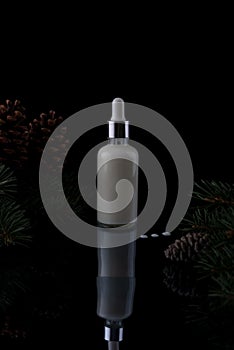 cosmetic serum white pine christmas bottle with pipette on black background