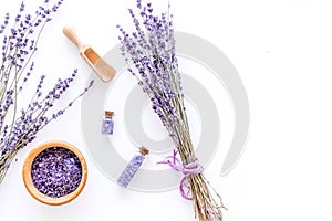 Cosmetic set with lavender herbs and sea salt in bottle on white table background flat lay mockup