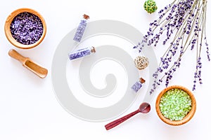 Cosmetic set with lavender herbs and sea salt in bottle on white table background flat lay mockup