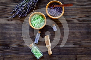 Cosmetic set with lavender herbs and sea salt in bottle on wooden table background flat lay mockup