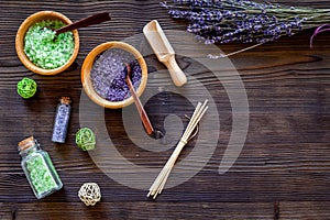 Cosmetic set with lavender herbs and sea salt in bottle on wooden table background flat lay mockup