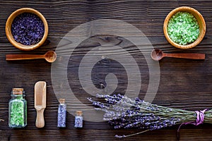 Cosmetic set with lavender herbs and sea salt in bottle on wooden table background flat lay mockup