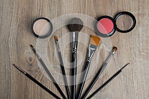 Cosmetic set of various shades compact and loose face powder, concealer and makeup brush.