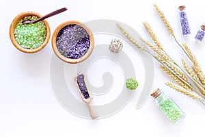 Cosmetic set with wheat herbs and sea salt in bottle on white table background flat lay