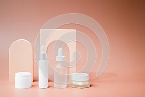 Cosmetic and skincare containers on beauty display background.