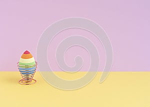 cosmetic sponge in the form of an egg on a mellifluous stand on a yellow-pink background. Copy space. photo