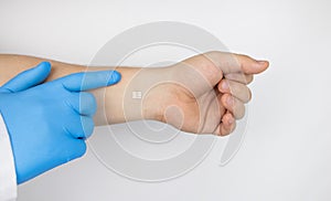 The cosmetic surgeon shows the patient`s hand with a biological chip. The concept of cybernetics, biotechnology and high-tech