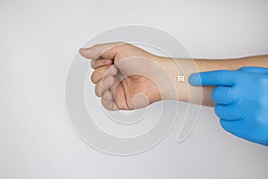 The cosmetic surgeon shows the patient`s hand with a biological chip. The concept of cybernetics, biotechnology and high-tech