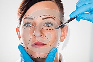 Cosmetic Surgery With Scalpel On Young Woman