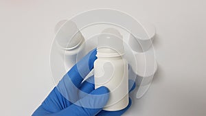 Cosmetic technician showing a deodorant and antiperspirant rollon container in the laboratory