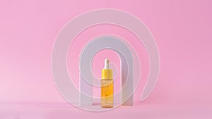 Cosmetic yellow bottle with vitamin c serum in arch. Skin care cosmetic. Hyaluronic acid oil, serum with collagen and peptides