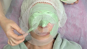 Cosmetician applying alginate face mask.